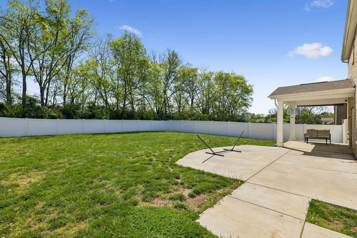 The backyard is the perfect place for games, playsets, and pets, and it includes a nice line of trees for extra privacy.