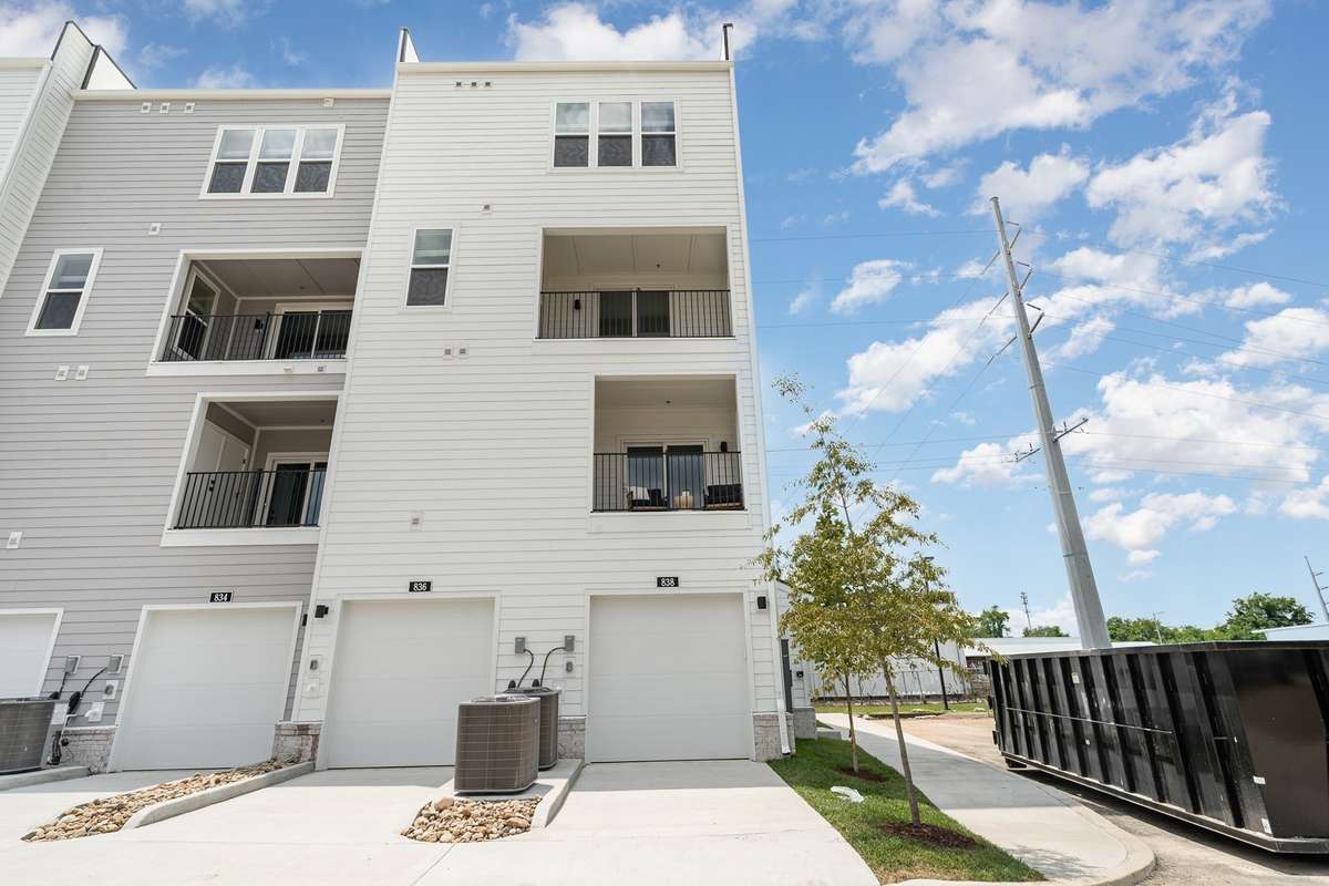 View of rear garage and Primary covered porch.  *Photos are of a similar floorplan with differing finishes and elevation.*