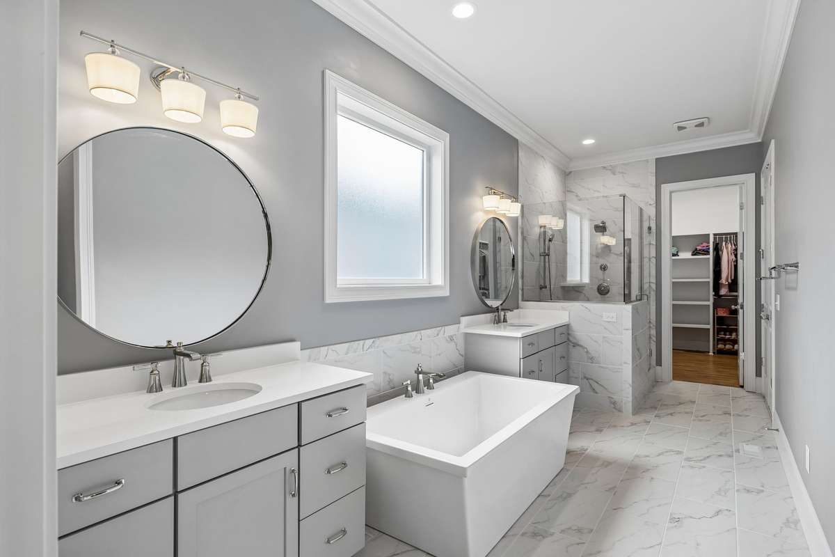Luxurious owners' bath featuring a soaking tub, walk-in shower, and generous space.