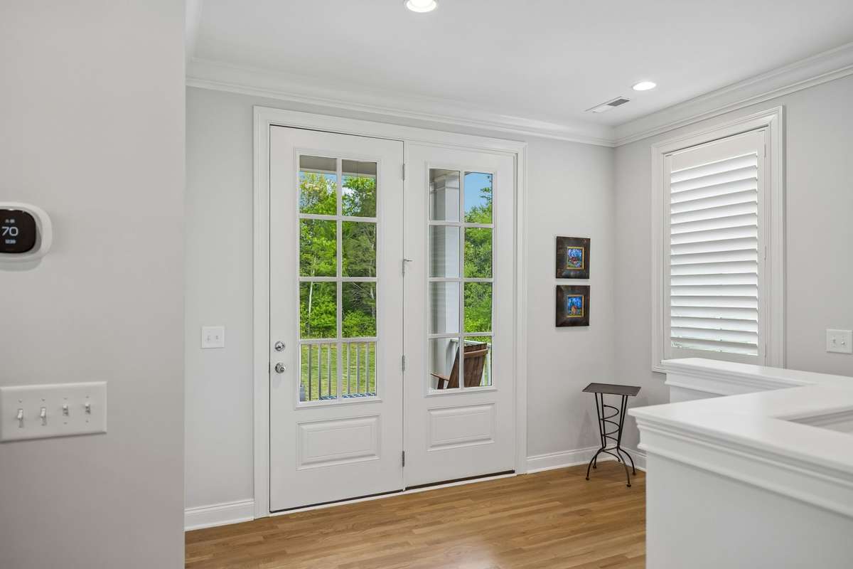 Upper-level landing that opens onto a charming second-story porch