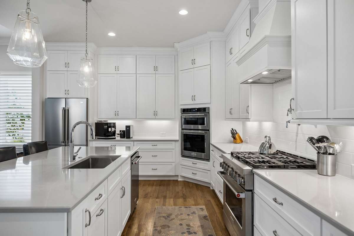 Well-appointed open kitchen boasting a gas range with pot filler, along with a built-in oven and microwave for added convenience.