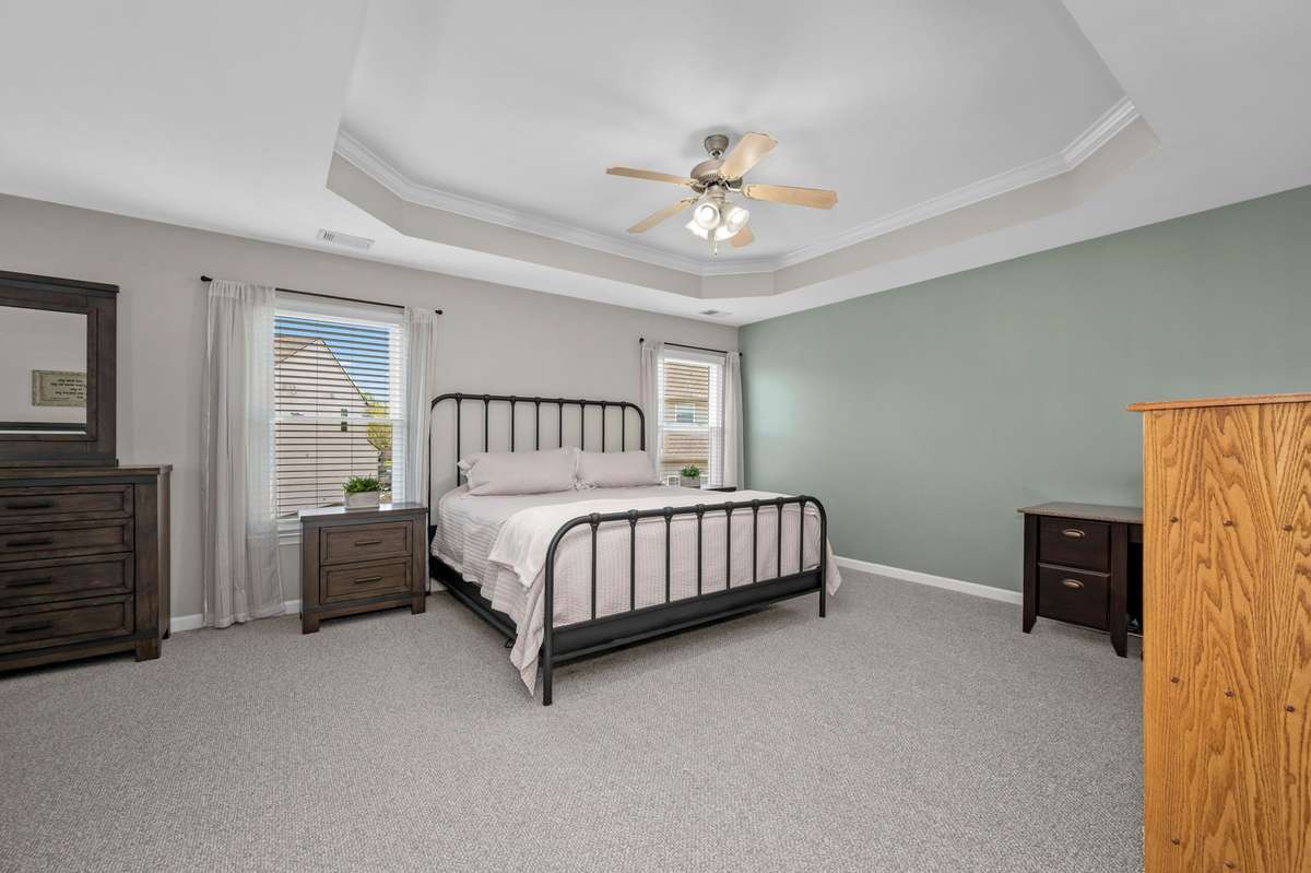 So much room in this upstairs primary suite with tray ceiling!
