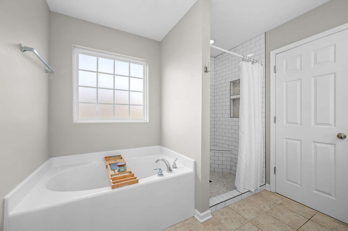 Soaking tub and tiled shower.