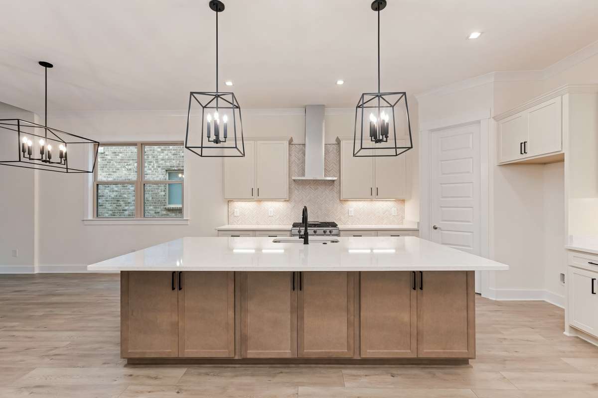 Open concept kitchen with large 8' Island that easily seats 6.Photos of previously built home.