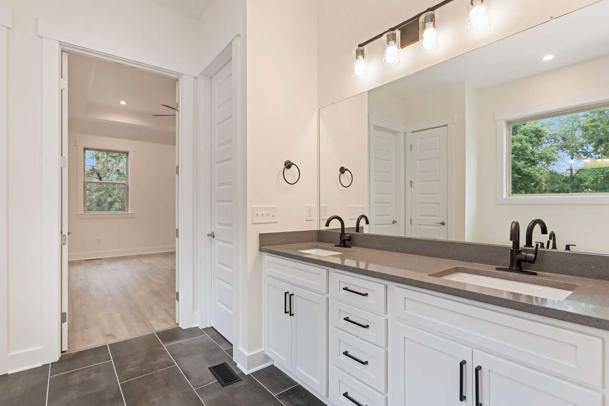 Primary bathroom with large oversized shower, freestanding tub and quartz countertops.