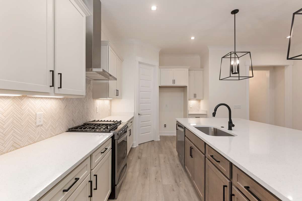 Stainless steel appliance, Tile backsplash, Quarts counter tops and large walk-in pantry create a beautiful kitchen.
