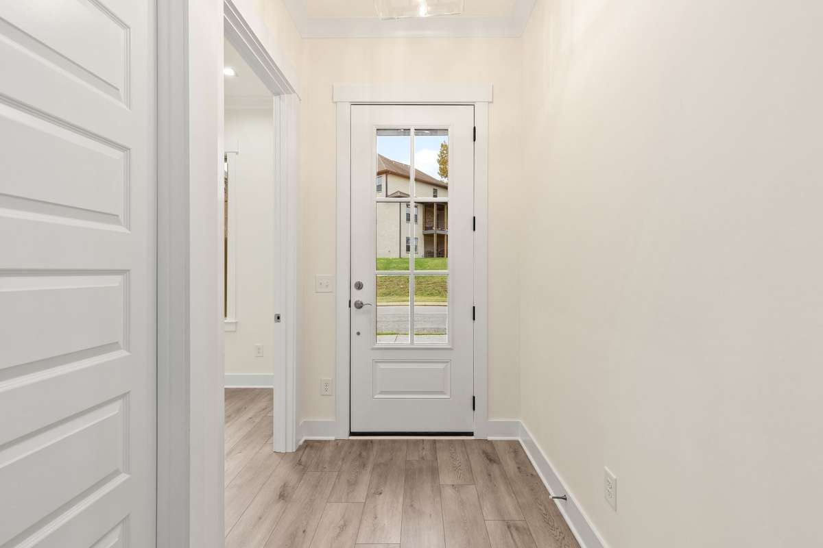 Sunny entry foyer with access to the home office.