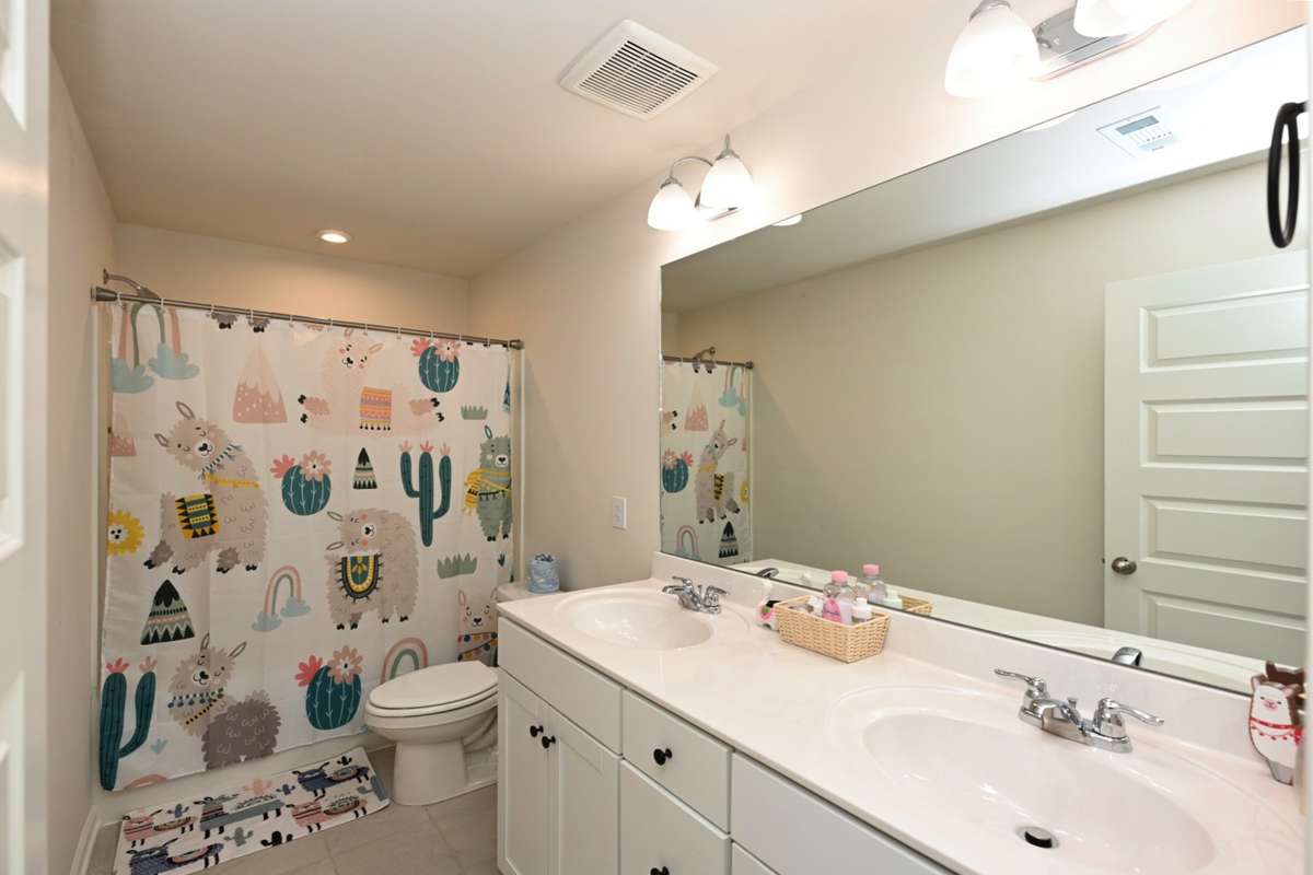 Master upstairs has tub shower combo with double vanities and tile floor