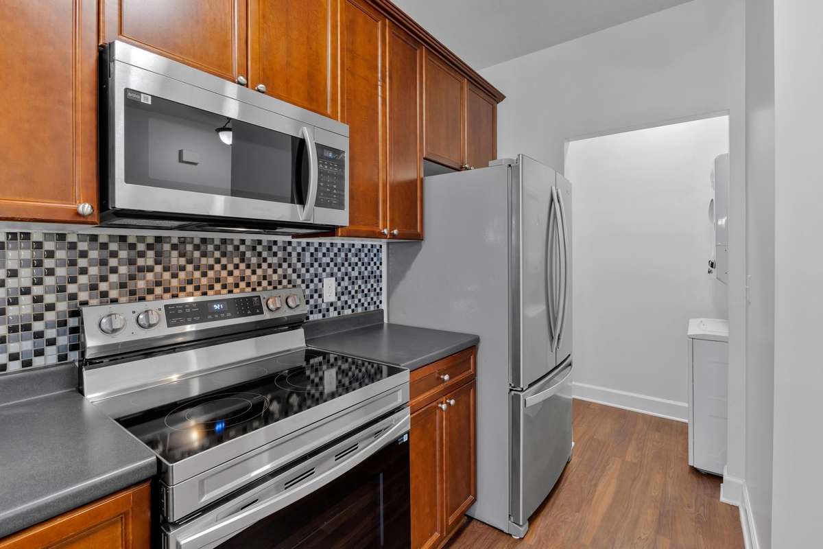 Utility room just beyond refrigerator
