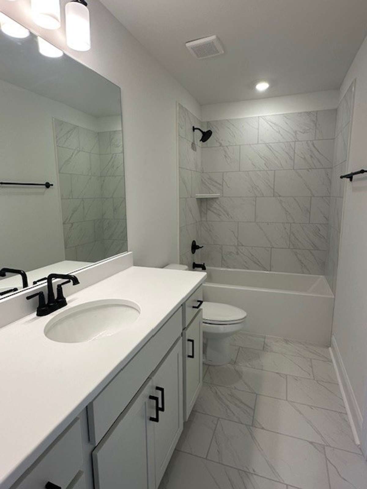 The 2nd Full Bath upstairs is tucked away as a private bath for bedroom #2, and showcases gleaming tile as well!