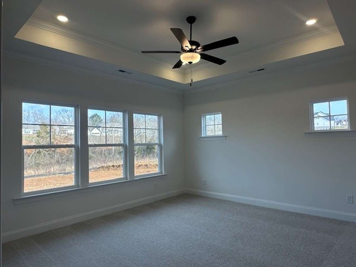 Your Primary Bedroom is on the main level, showcasing a trey ceiling, plenty of lighting, decorative crown moulding, lots of windows and 2 closets!