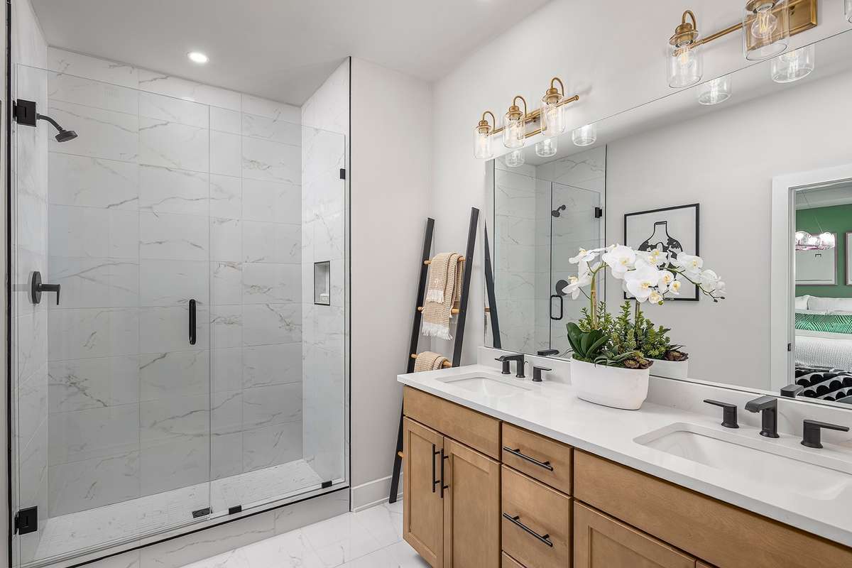 Primary bath with floor to ceiling tiled shower. *Photos are of a similar floor plan with different finishes and are for representational purposes only*