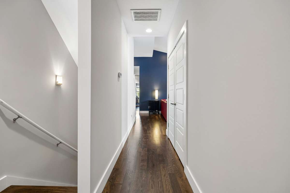 Continuing through the second-floor hallway, enjoy hardwood floors and 9 ft ceilings throughout.