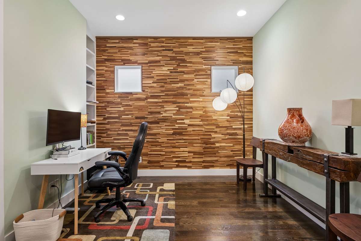 First-floor flex space ideal for a home office or study, featuring hardwood floors and built-in shelving for added storage.