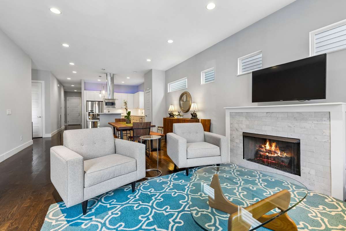 As you enter, you’re welcomed into an open-concept layout featuring the living, dining, and kitchen areas.