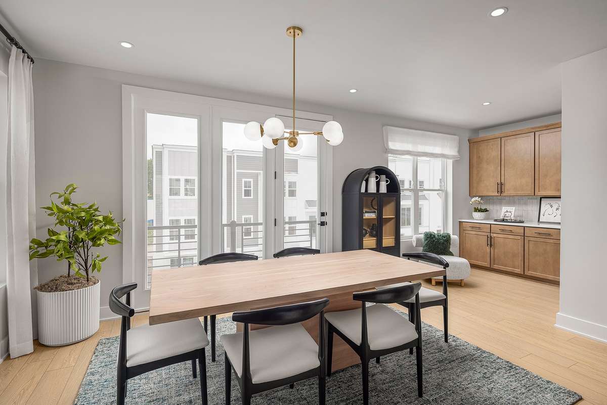 Adjacent to the main workspace, a dedicated dining nook accommodates a full‑size table for family meals. Large windows bring in natural light, enhancing the open, airy feel.*Photos are of a similar floorplan with differing finishes*