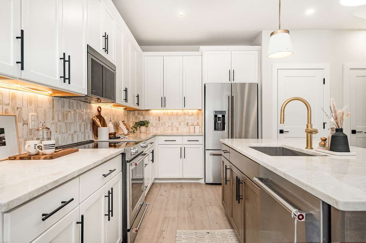 The kitchen features ample cabinetry, modern appliances, and generous counter space, making it ideal for everyday cooking or entertaining.*Photos are of a similar floorplan with differing finishes.*
