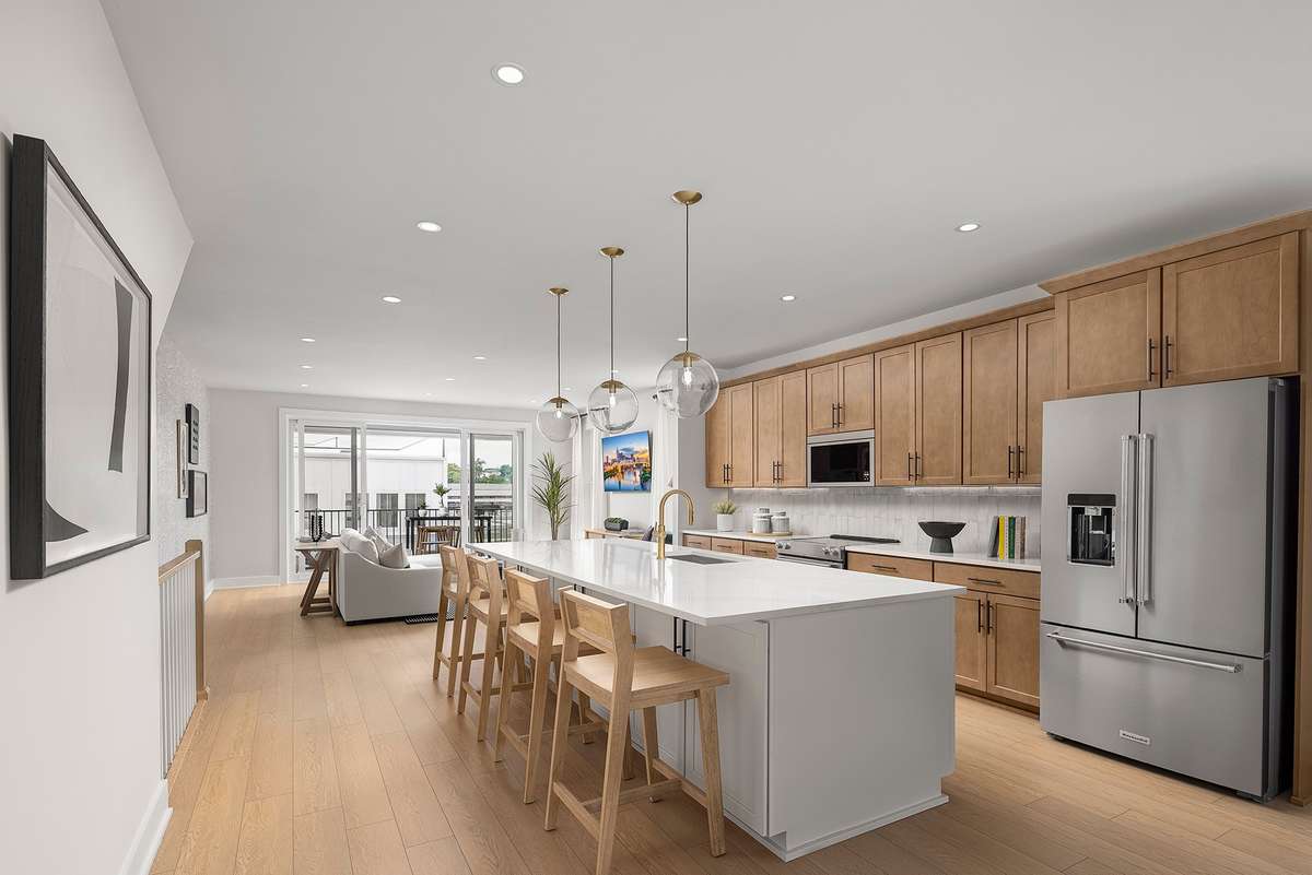A spacious central island anchors the room, offering additional prep space, casual seating, and convenient storage. Stunning Kitchen with Kitchen Aid appliances *Photos are of a similar floorplan with differing finishes*