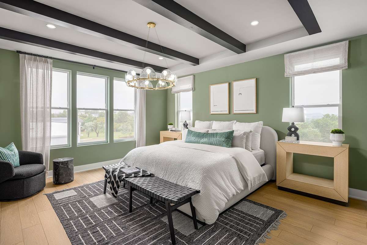 The primary bedroom offers a spacious and serene retreat designed for comfort and relaxation.*Photos are of a similar floorplan with differing finishes*