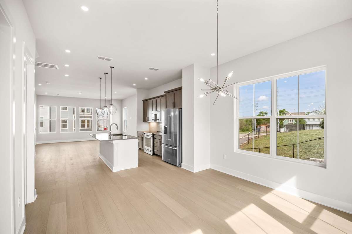 The dining area & living room are separated by the designer-selected kitchen with an island for casual bar seating.
