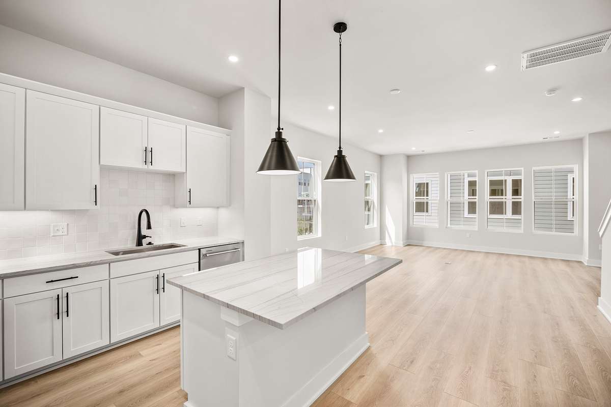 The main floor features a an open living area & kitchen with tons of natural light.