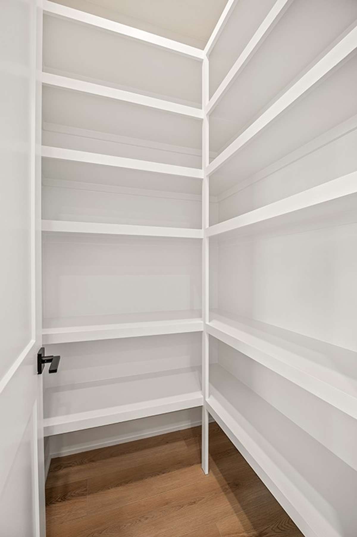The pantry features built-in custom shelving!