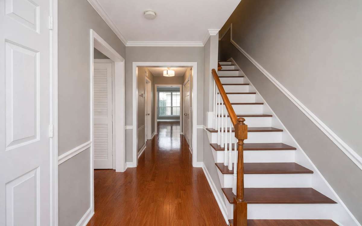 Upon entry, you're welcomed by an inviting foyer, coat closet, hardwood floors, and fresh paint.