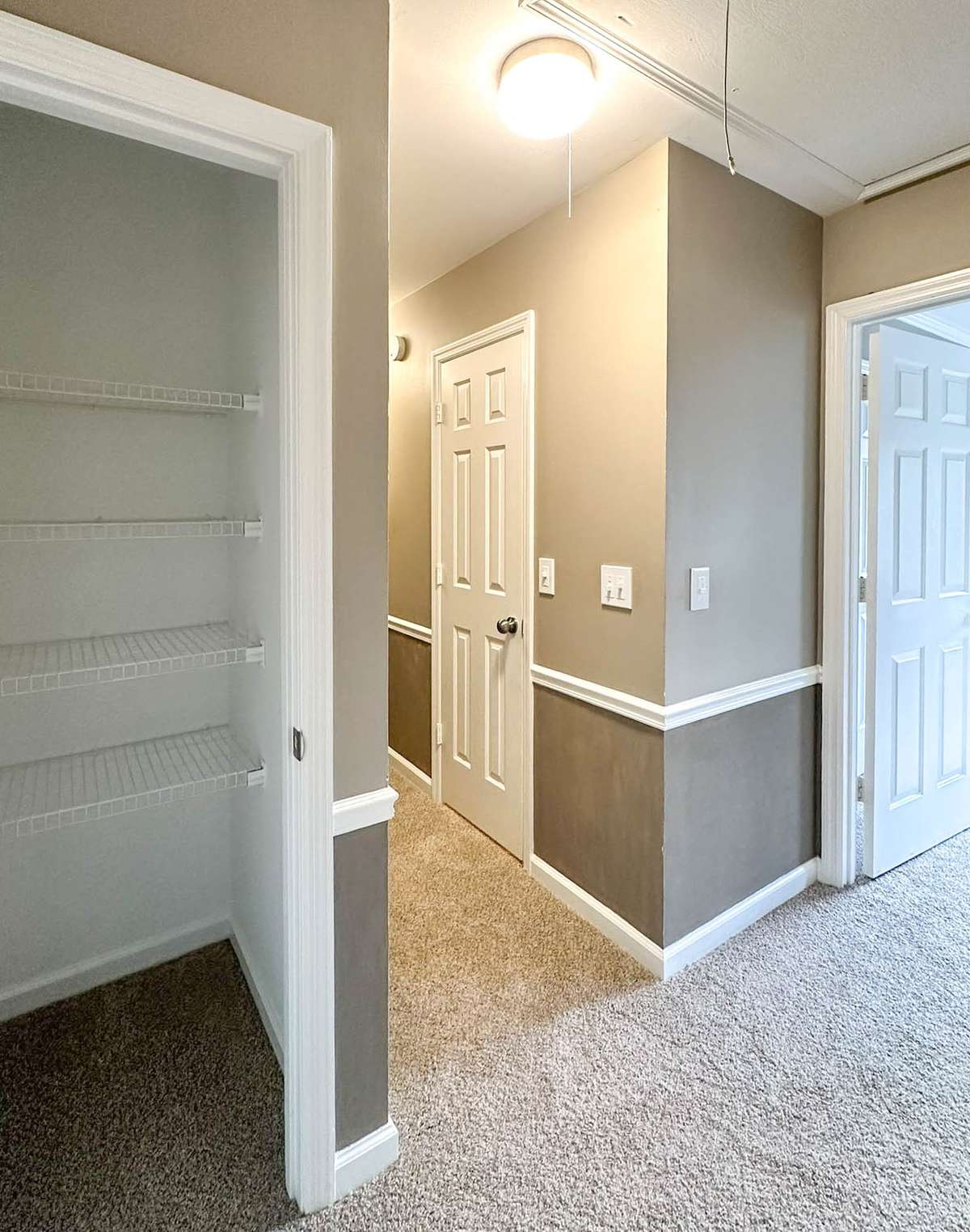 Linen closet across from secondary bath, adding functional storage.