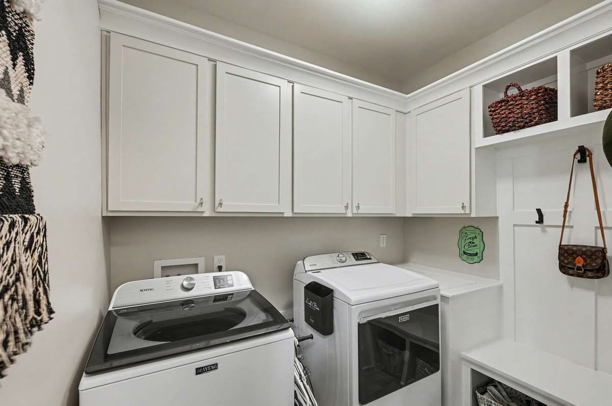 *Two Laundry Spaces for your convenience. One on each level. This is the space on the main floor. Extra deep storage option next to the dryer and more cabinet storage above.