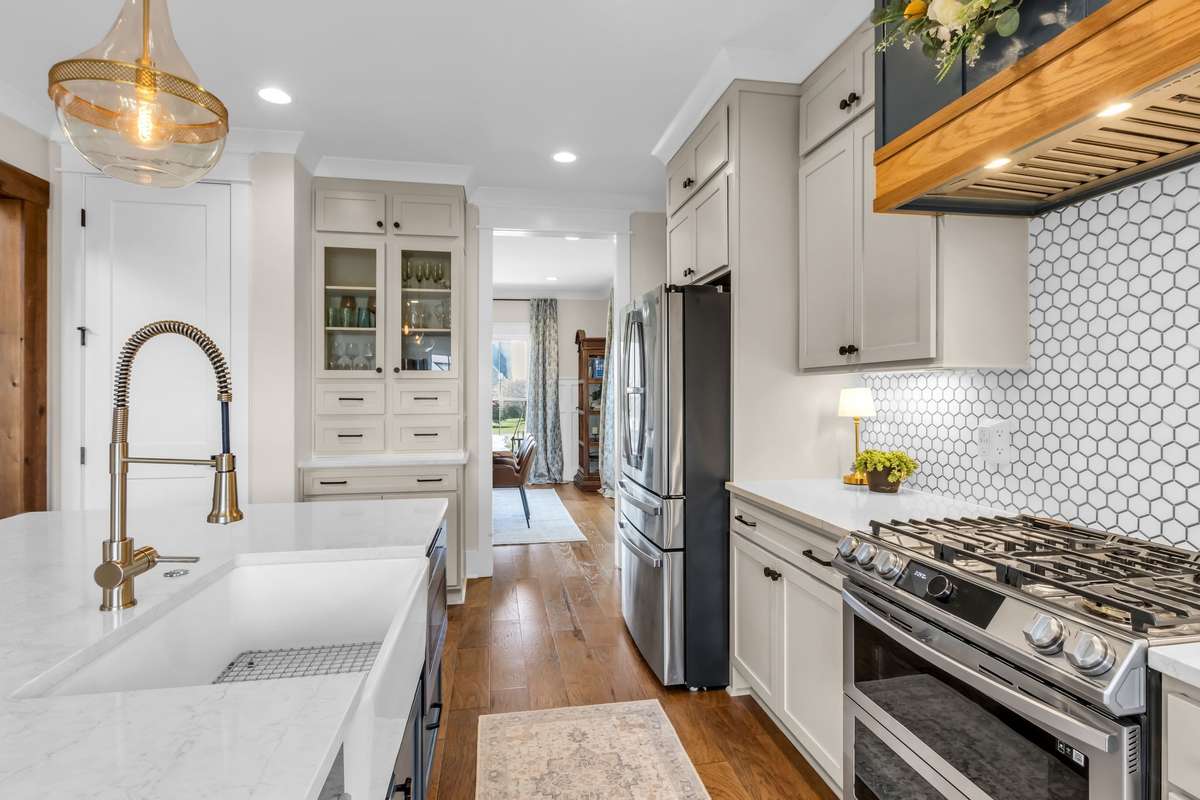 Farm Sink, pullout trash, and under counter microwave are housed in the island.