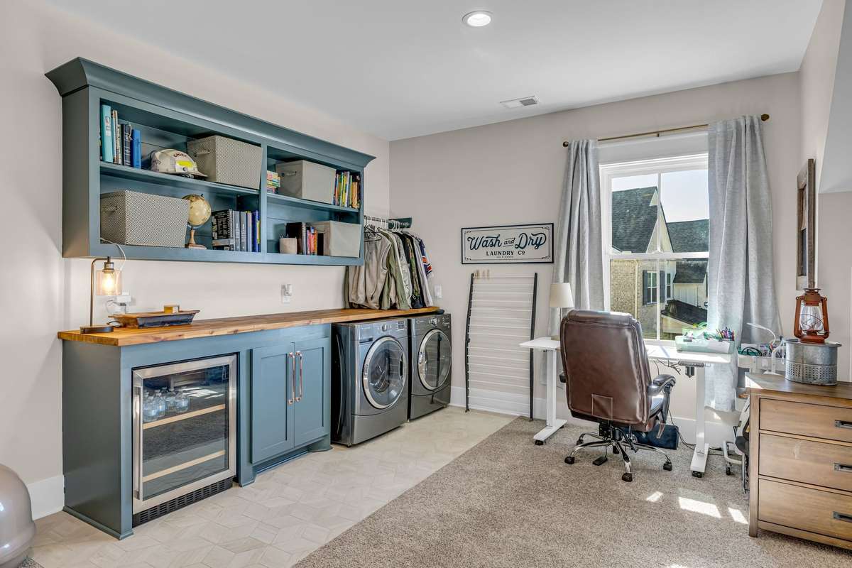 Upstairs** second laundry area in the bonus room (teen suite shown) This versatile space features custom storage and generous counter space for sorting and folding laundry or make this a hobby room or office. Built in under counter beverage cooler.