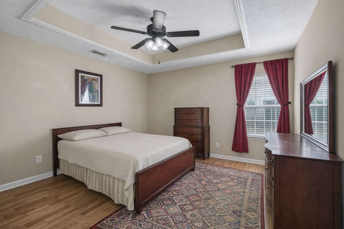 Primary bedroom with trey ceiling, neutral color scheme & window. 2739 Oxford Hall Ave. Murfreesboro, TN 37128