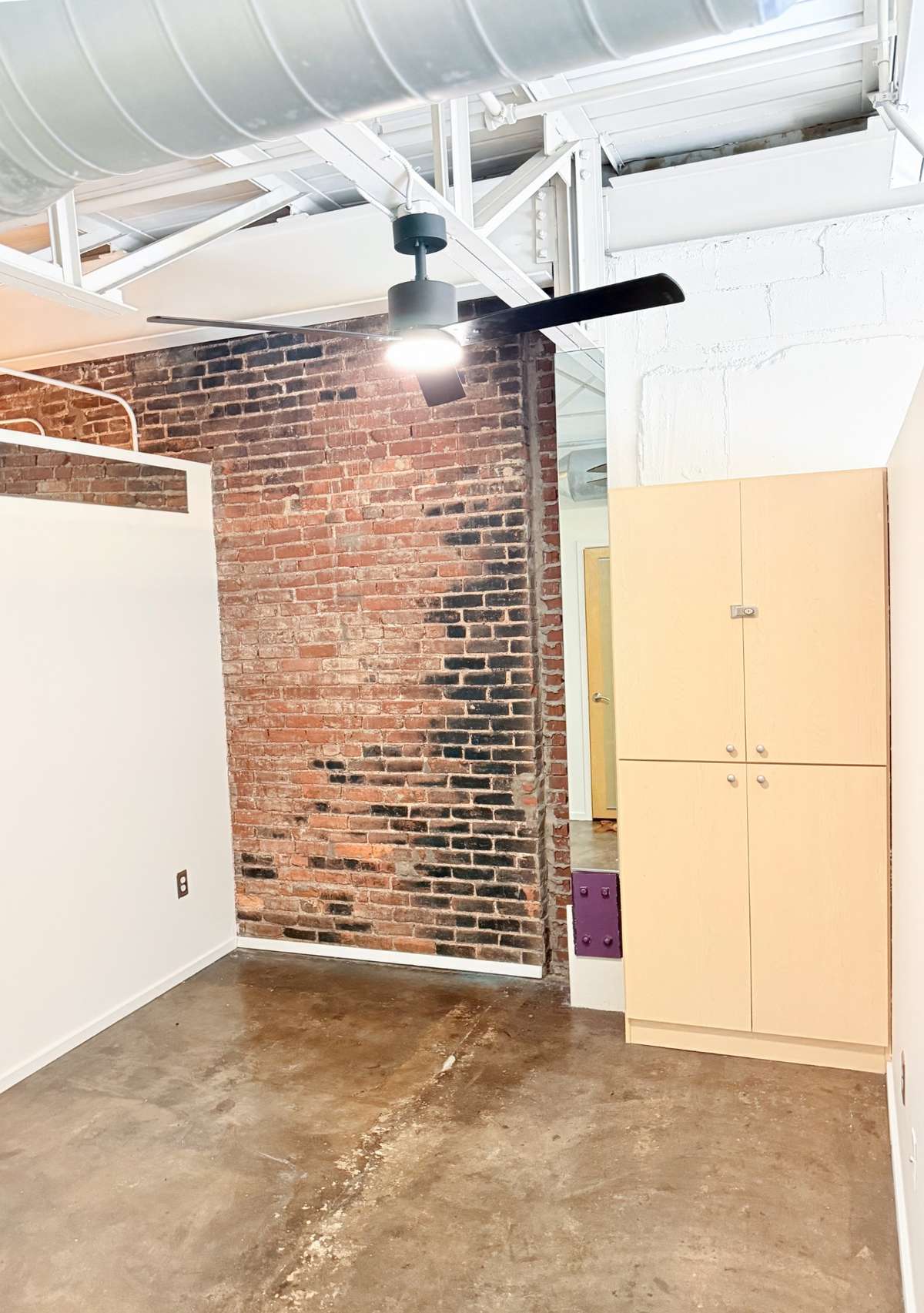 2nd flex space bedroom with storage, exposed brick and a new ceiling fan