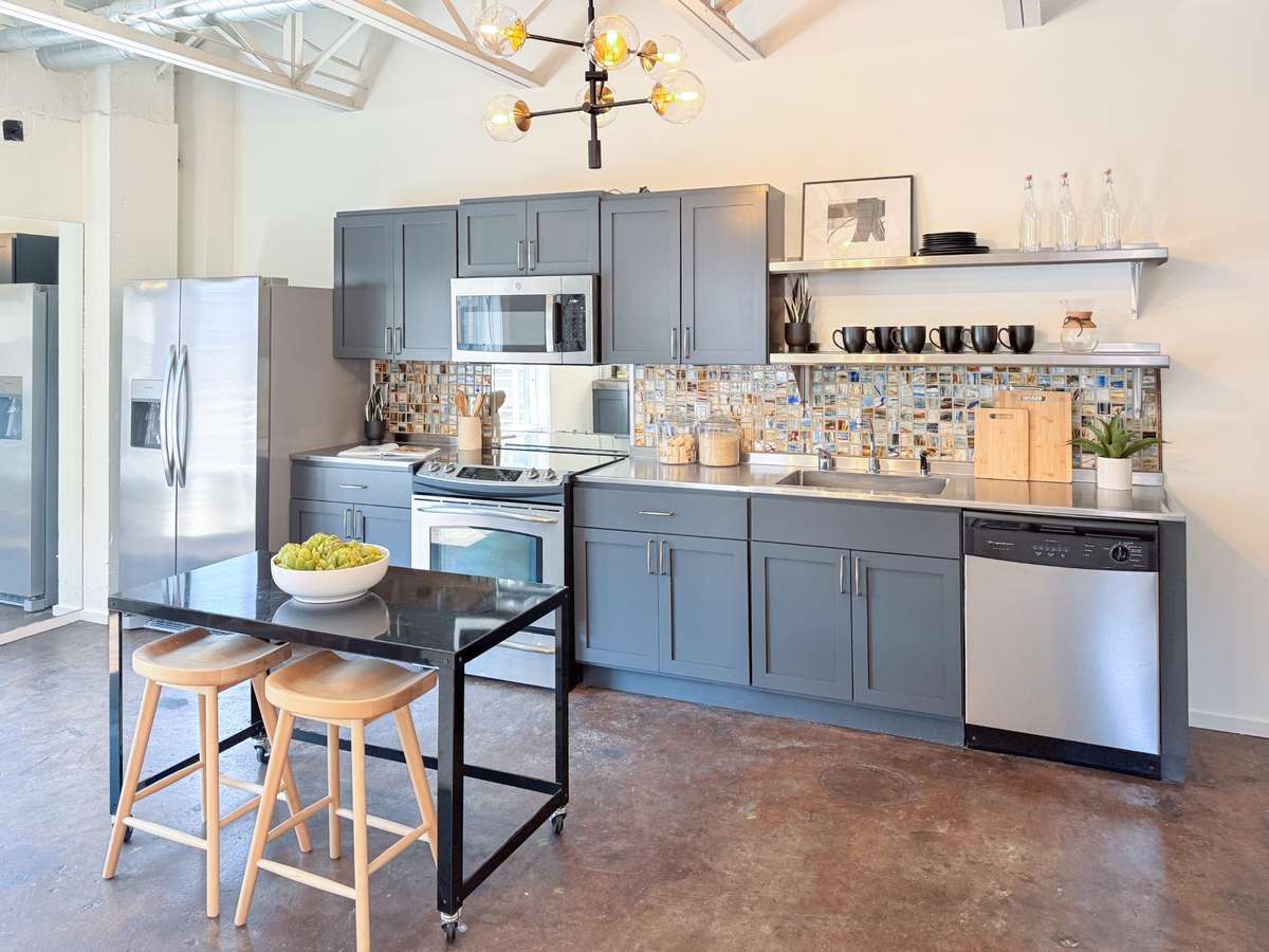 Open kitchen with updated lighting, clean lines and seamless flow into the living space.