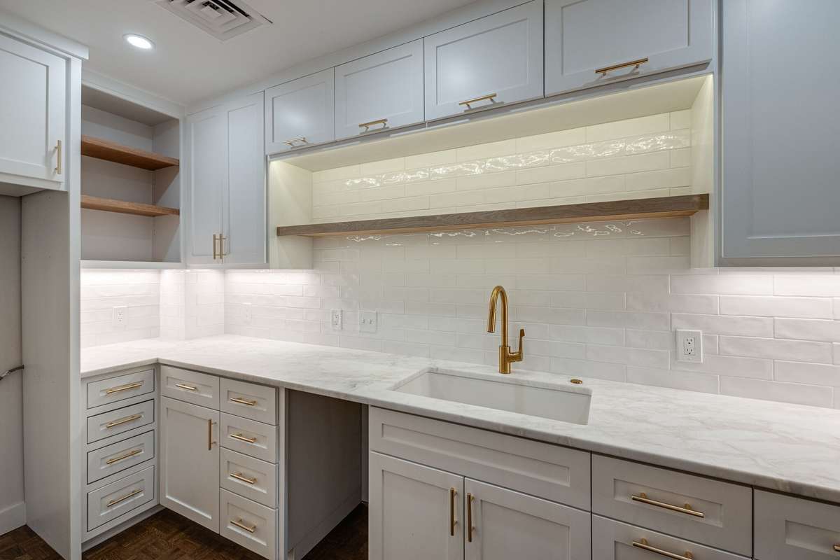 Renovated to the studs, this thoughtfully design kitchen features marble countertops, tile backsplash, custom cabinetry with gold hardware, hidden pullouts, and top of the the line appliances (appliances pictured in the previous photo.)