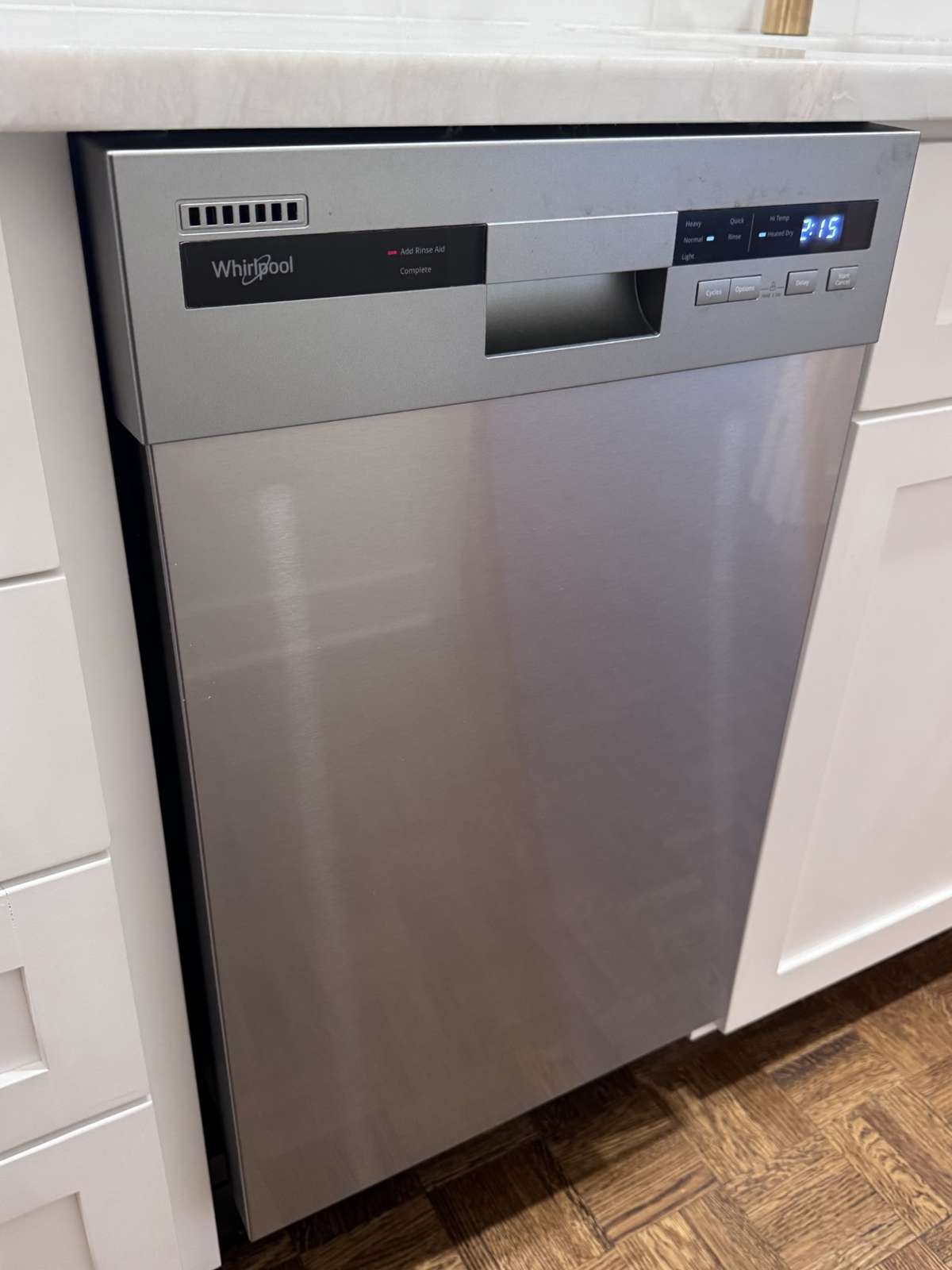 All appliances are new including this special order cabinet size stainless steel whirlpool dishwasher, complimenting the custom kitchen flawlessly.