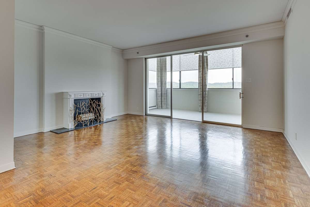 Elegant and spacious, the living room is ready for your touch with creamy soft paint and natural light from the sun porch.