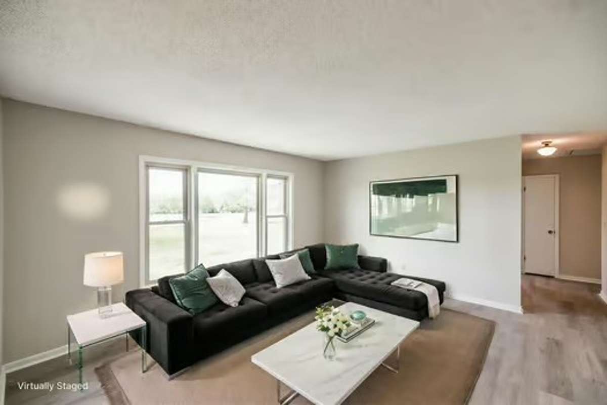 Virtual staging of the front living room overlooking the incredible front yard