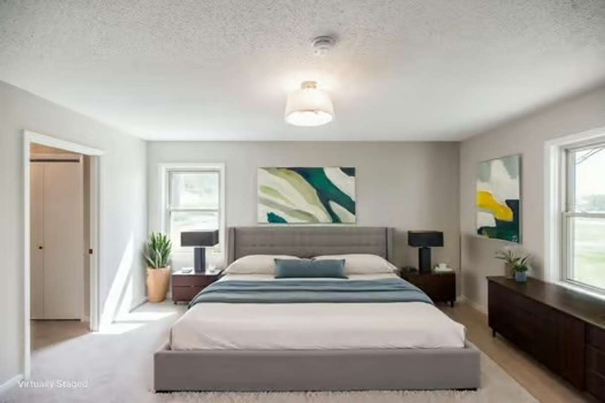 Virtual staging of the primary suite on the main level with attached full bath