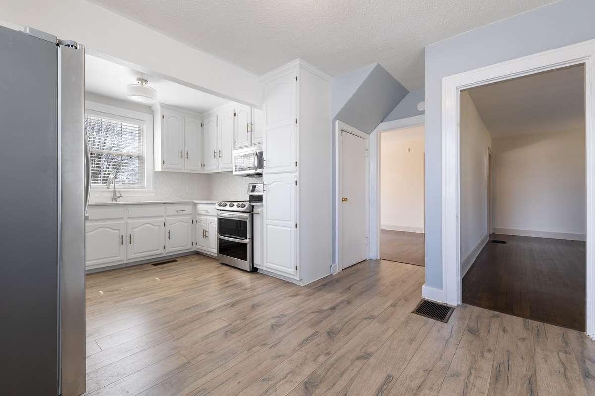 So much natural light fills this kitchen. Pantry closet added for additional storage.
