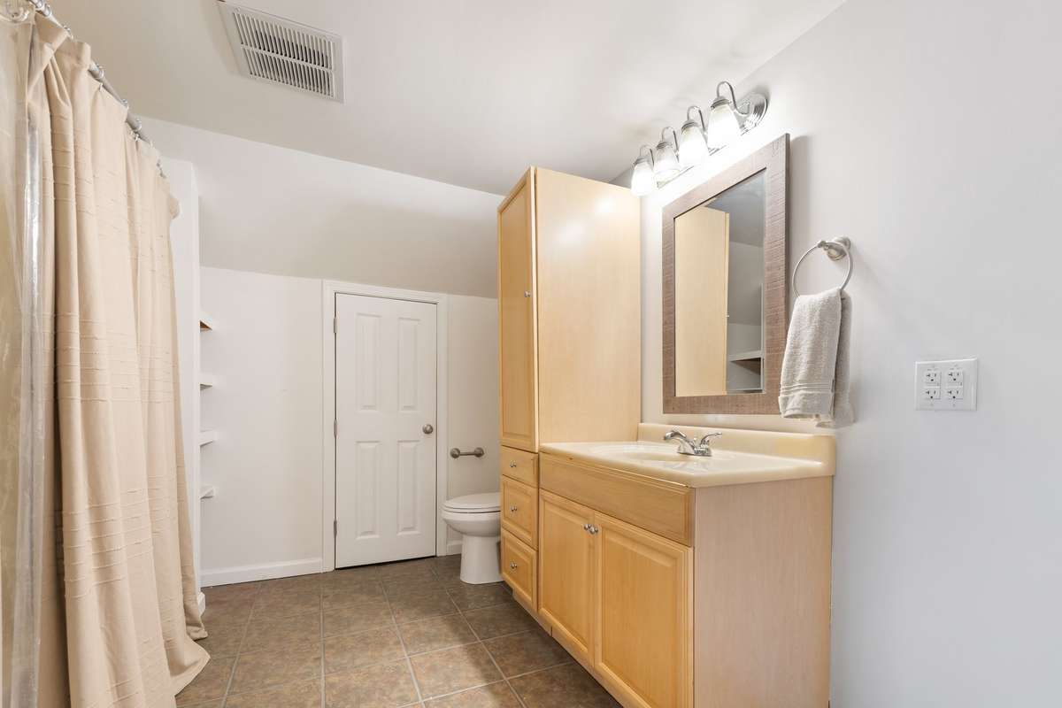 Oversized bathroom has two smaller closets on each end
