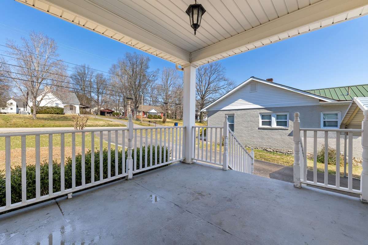 The property features a covered front porch as well as a covered back deck.