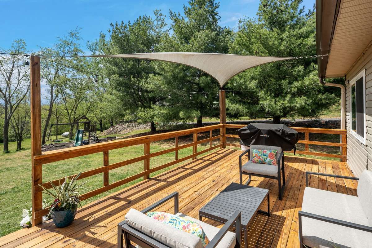 Come and enjoy this massive open deck with built-in railing and peaceful backyard views. A great space for entertaining and grilling out.