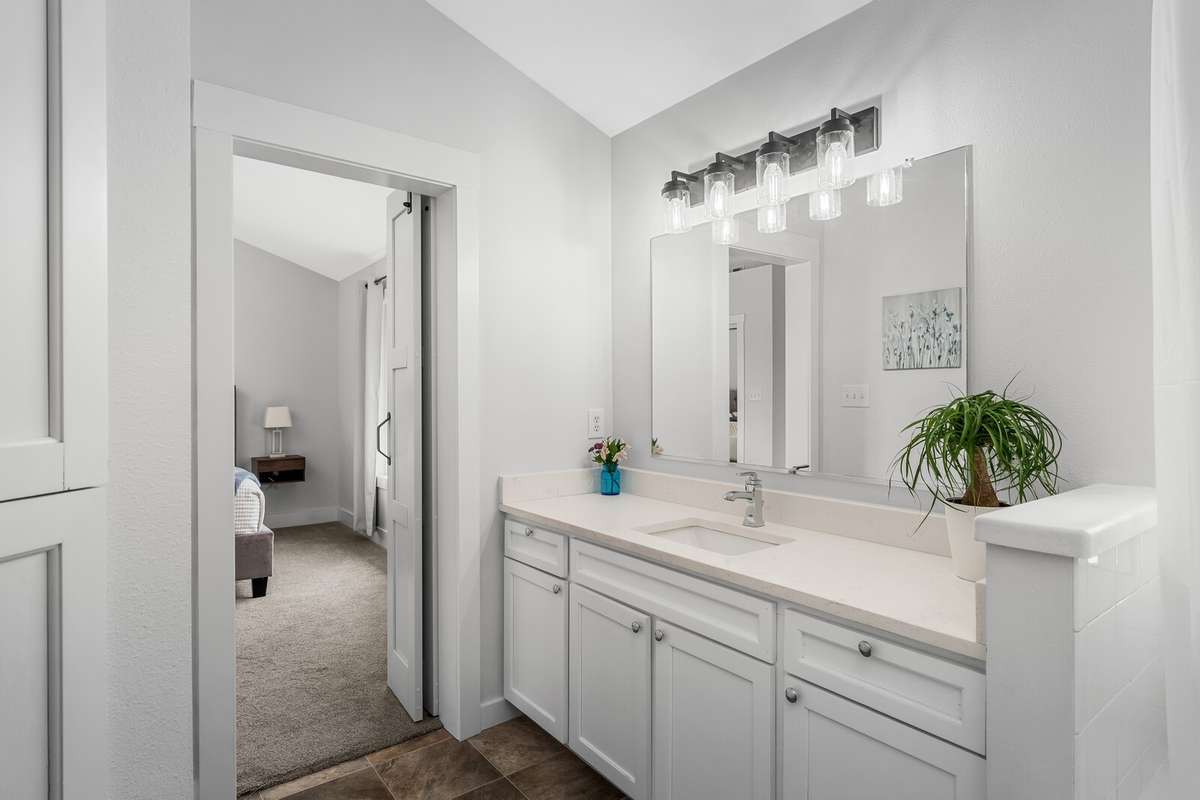An additional view of the primary bath cabinets and sink.