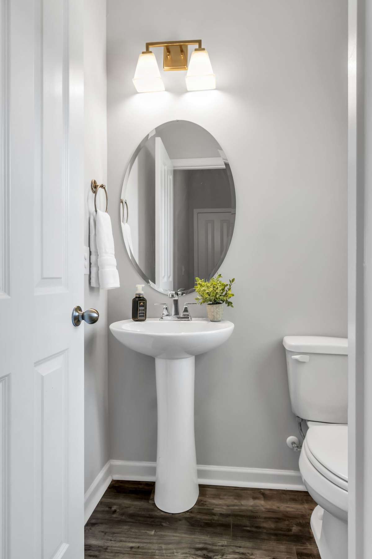 Downstairs powder room with pedestal sink.