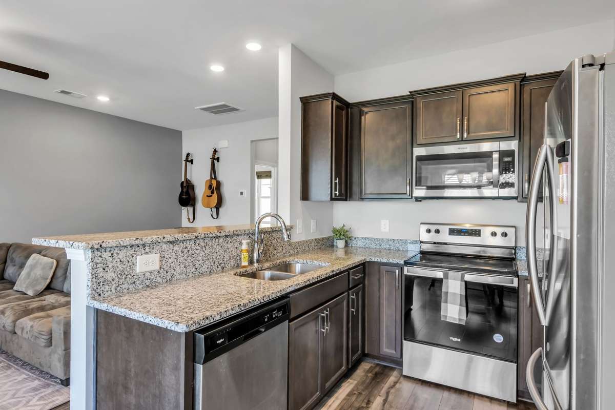 Kitchen open to living room, lots of counter space & cabinets.