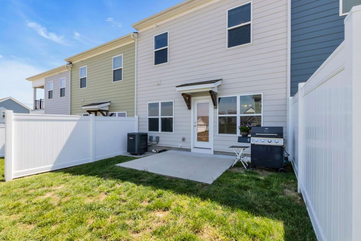 Covered rear entry, low maintenance yard.