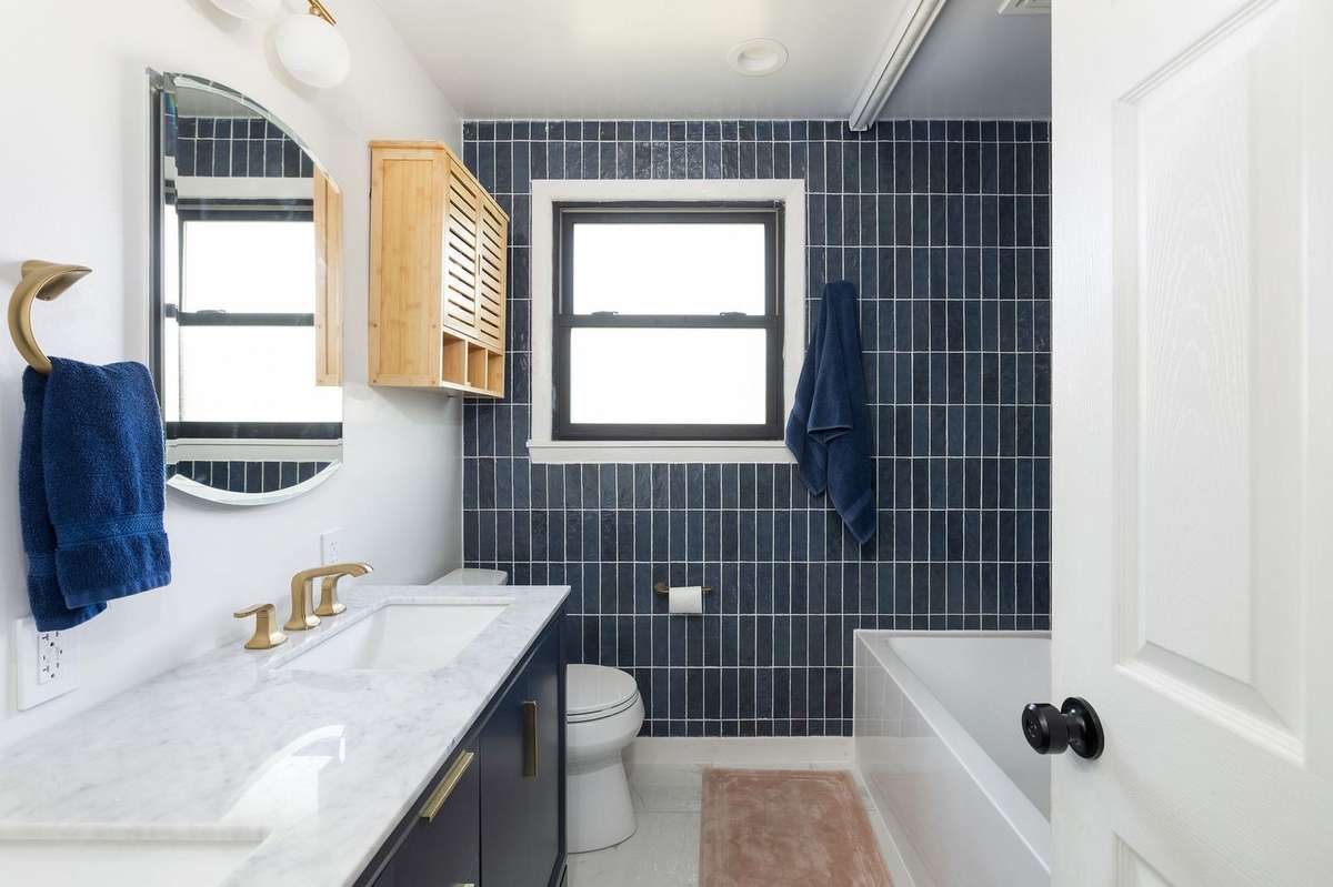 This bathroom has been completely modernized: double vanity, soaking alcove tub, gorgeous tile to the ceiling, and supreme shower system.