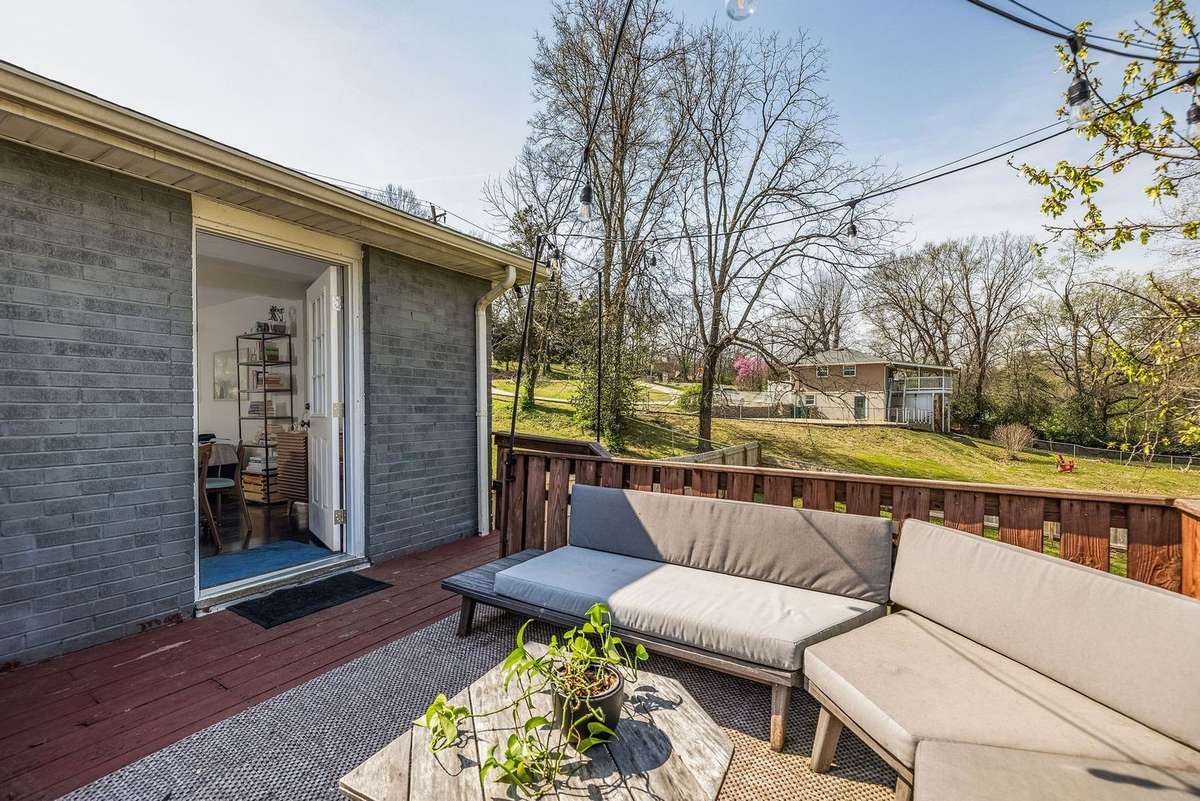 outdoor deck looking over more than 1/2 a verdant acre