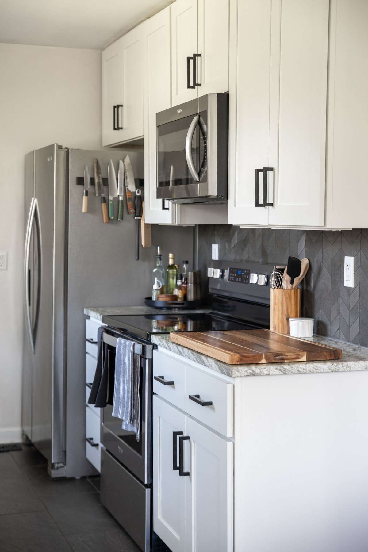 Stone backsplash, new cabinetry, and stainless appliances